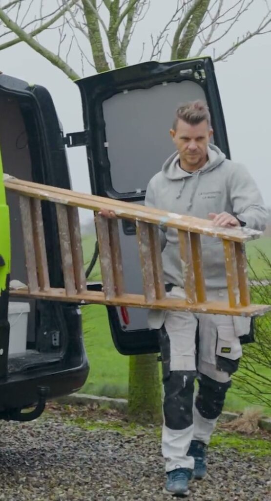 Maler tager stige ud af varebil